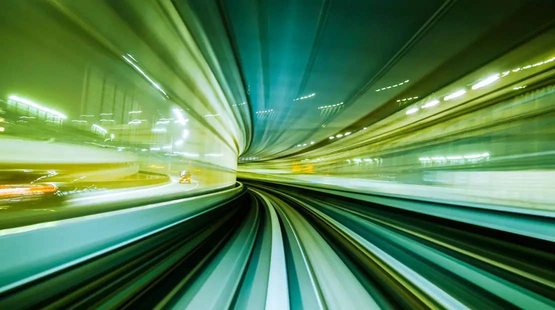 Railway line captured in motion with light trail effects, a symbol of speed and energy.