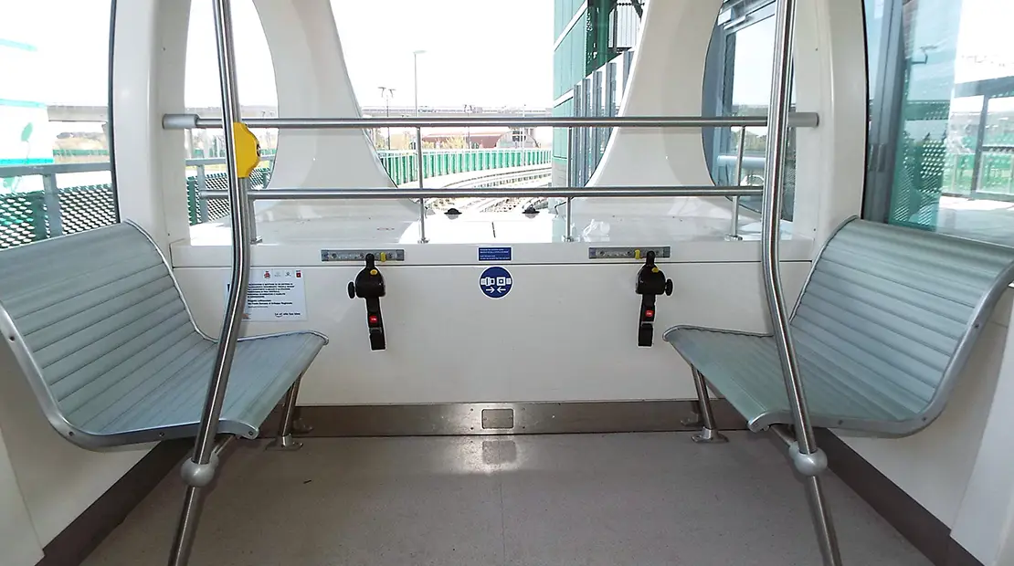 Interior of the Pisa Mover shuttle with side seats and an area equipped for people with disabilities.